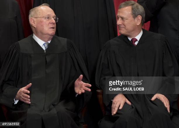Chief Justice of the United States John G. Roberts and US Supreme Court Associate Justice Anthony M. Kennedy sit for an official photo with other...