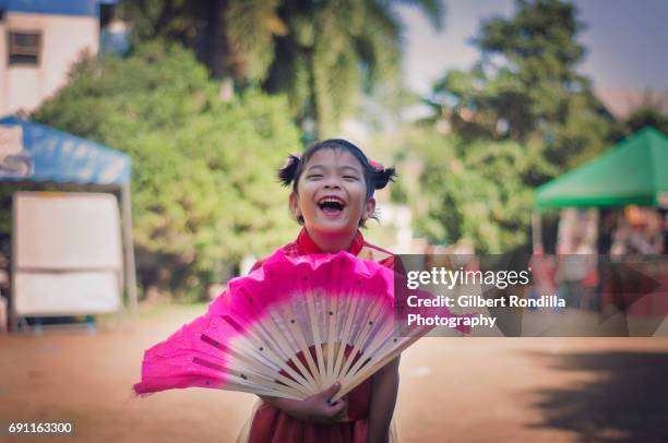 girl with pink fan - philippines girl stock-fotos und bilder