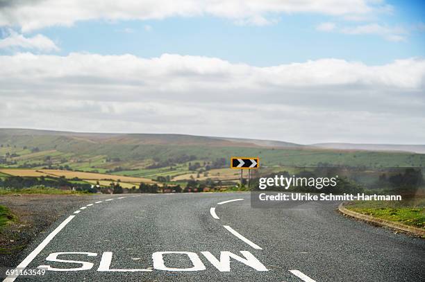 sharp bend of road - slow stock-fotos und bilder