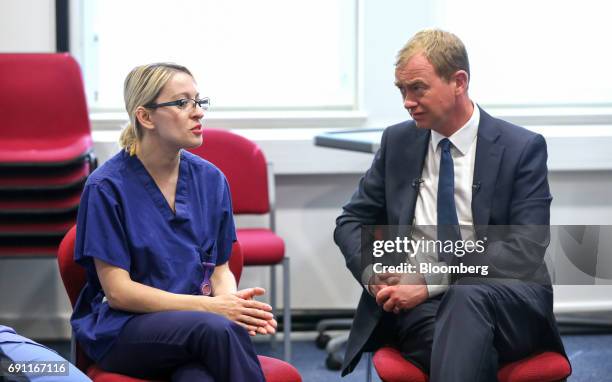 Tim Farron, leader of the Liberal Democrats, right, speaks with a nurse on a visit to Kingston hospital during a general-election campaign stop in...