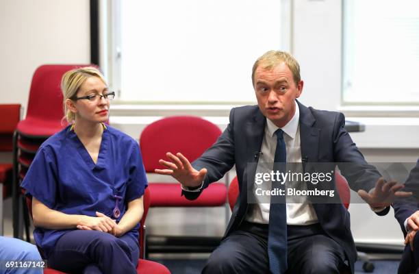 Tim Farron, leader of the Liberal Democrats, right, speaks with NHS staff on a visit to Kingston hospital during a general-election campaign stop in...