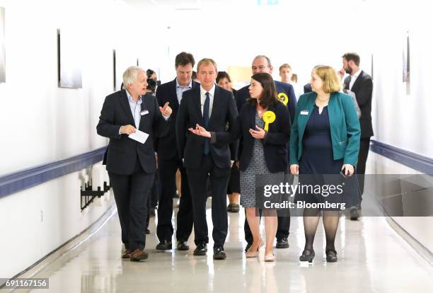 Tim Farron, leader of the Liberal Democrats, centre, and Sarah Olney, Liberal Democrats candidate, centre right, speak with staff at Kingston...