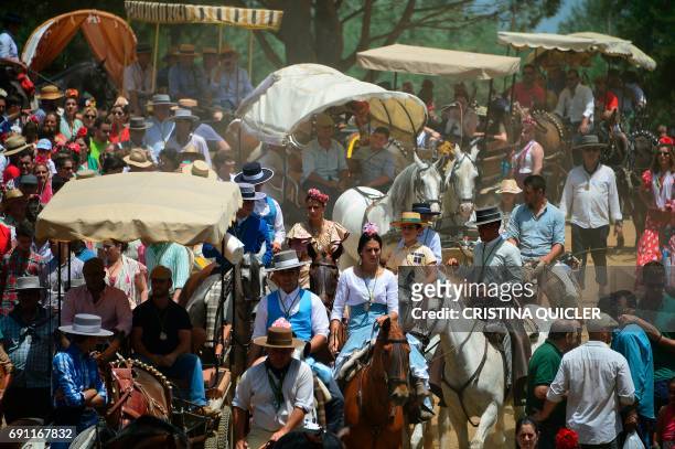 Pilgrims on horses, carts or by foot cross the Quema river during the annual El Rocio pilgrimage in Villamanrique, near Sevilla on June 1, 2017. El...