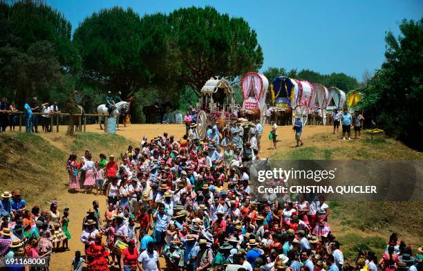 Pilgrims walk followed by wagons moments before crossing the Quema river during the annual El Rocio pilgrimage in Villamanrique, near Sevilla on June...