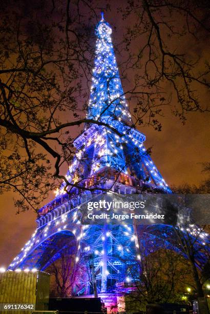 View of the Eiffel tower illuminated in blue displaying the European symbol due to the French presidency of the European Union.