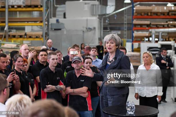 Theresa May, U.K. Prime minister and leader of the Conservative Party, speaks to workers during a general-election campaign tour stop at Ultima...