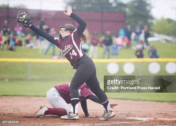 Noble's Jordan Boucher attempts to get Windham's Chloe Wilcox out while leading off first during their game at Windham High School.