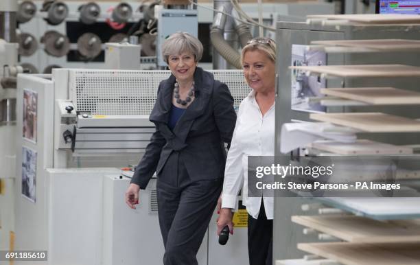 Conservative party leader Theresa May with Clare Ellis owner of Ultima Furniture in Pontefract, West Yorkshire, while on the General Election...