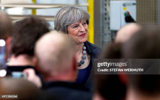 Britain's Prime Minister Theresa May attends a 'question and answer' session with staff at Ultima Furniture in Pontefract, west Yorkshire on June 1...