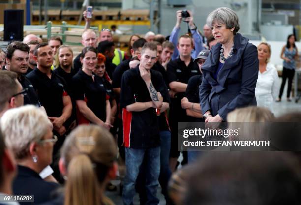 Britain's Prime Minister Theresa May attends a 'question and answer' session with staff at Ultima Furniture in Pontefract, west Yorkshire on June 1...