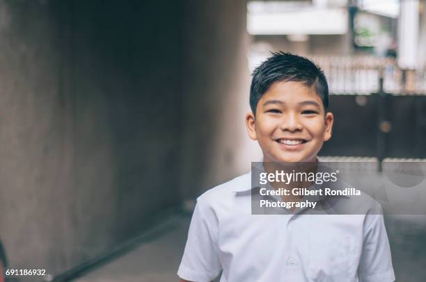 schoolboy - asian young boy smiling stock pictures, royalty-free photos & images