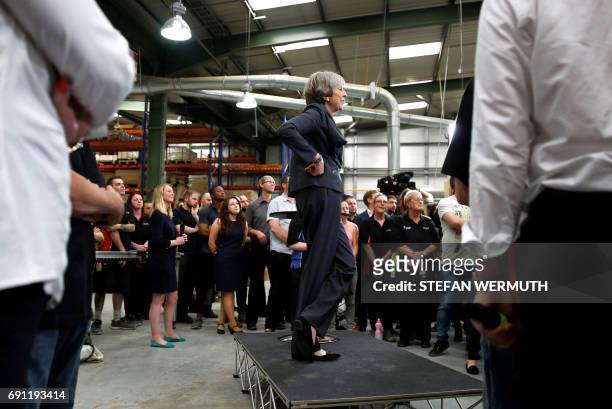 Britain's Prime Minister Theresa May attends a 'question and answer' session with staff at Ultima Furniture in Pontefract, west Yorkshire on June 1...