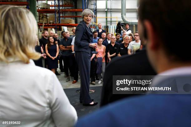 Britain's Prime Minister Theresa May attends a 'question and answer' session with staff at Ultima Furniture in Pontefract, west Yorkshire on June 1...