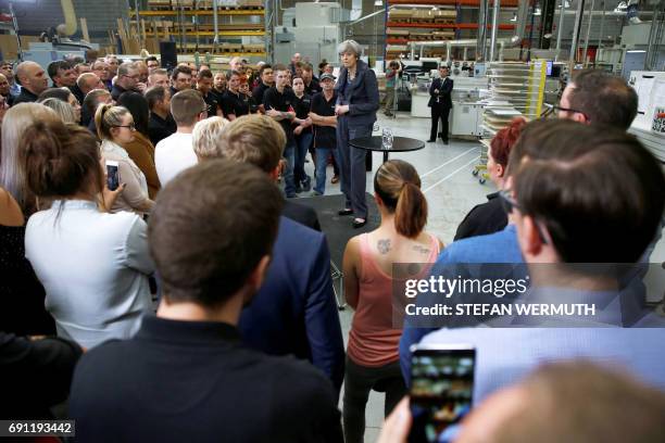 Britain's Prime Minister Theresa May attends a 'question and answer' session with staff at Ultima Furniture in Pontefract, west Yorkshire on June 1...