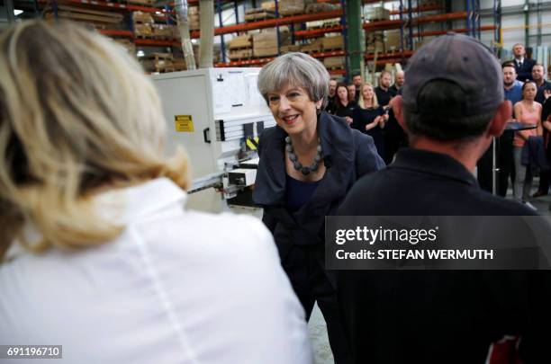 Britain's Prime Minister Theresa May attends a 'question and answer' session with staff at Ultima Furniture in Pontefract, west Yorkshire on June 1...