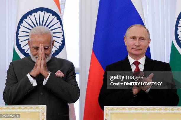 Russian President Vladimir Putin and Indian Prime Minister Narendra Modi attend a signing ceremony following their meeting on the sidelines of the...