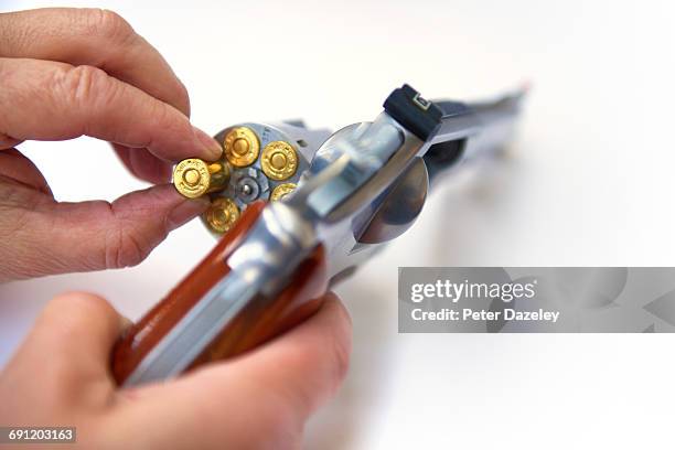 loading hand gun with copy space - crimine con arma da fuoco foto e immagini stock