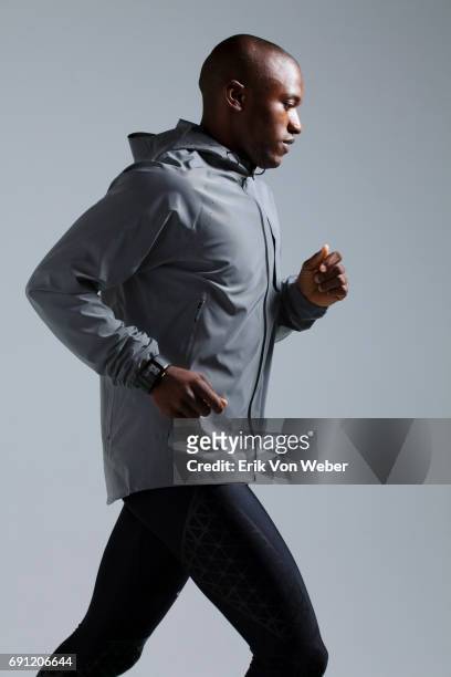 man running in studio wearing workout apparel - running man profile stock pictures, royalty-free photos & images