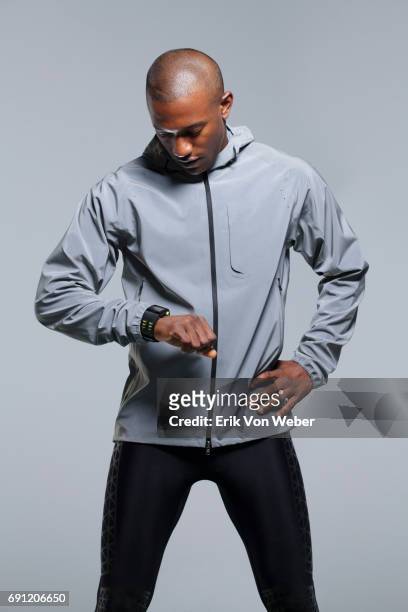 man running in studio wearing workout apparel - hi tech sports gear foto e immagini stock