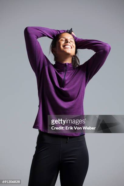 woman wearing running apparel in studio - top capo di vestiario foto e immagini stock