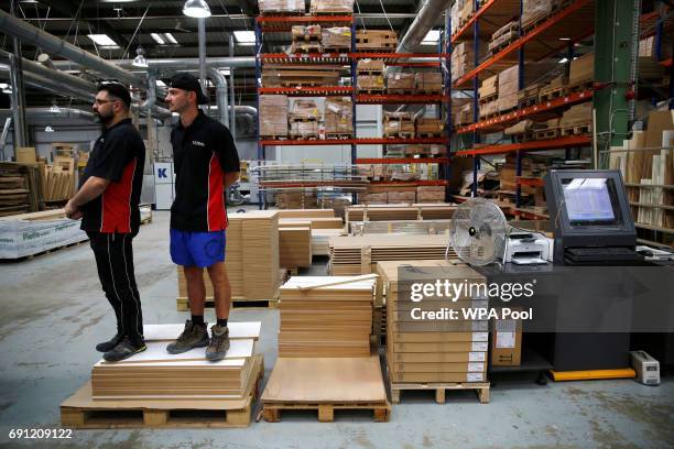 Staff watch as Britain's Prime Minister Theresa May attends an election campaign event at Ultima Furniture on June 1, 2017 in Pontefract, United...