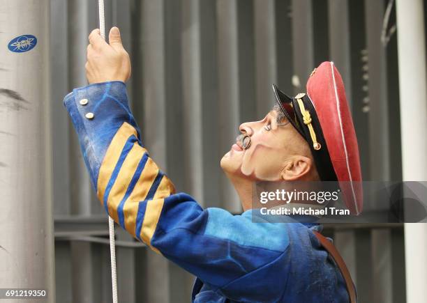 Sgt. Pepper' from The Beatles LOVE by Cirque du Soleil raising the flag of the 50th Anniversary Celebration of The Beatles' "Sgt. Pepper's Lonely...