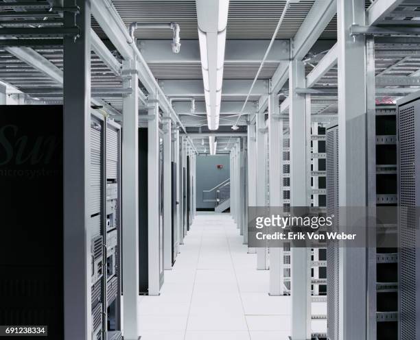 interior shot of server room hallway - server di rete foto e immagini stock