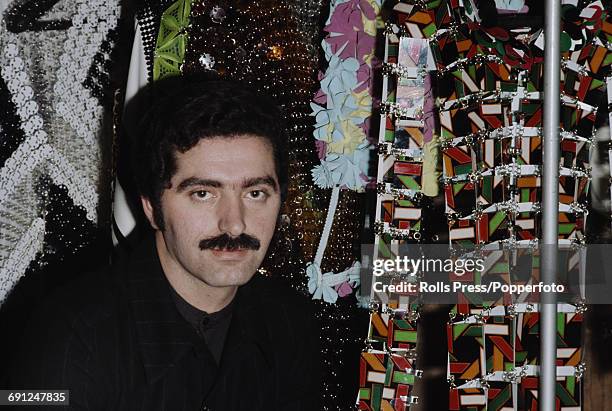 Spanish born French fashion designer Paco Rabanne in front of a rail of dresses from his latest collection in February 1969.