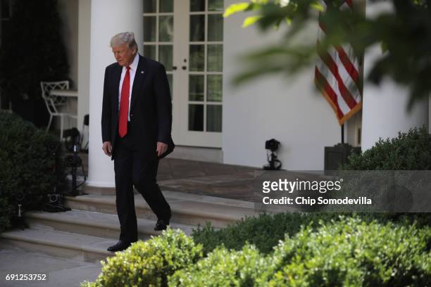 President Donald Trump arrives to announce his decision regarding the United States' participation in the Paris climate agreement in the Rose Garden...