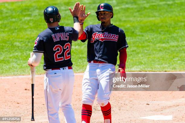 Jason Kipnis celebrates with Francisco Lindor of the Cleveland Indians after both scored on a single by Michael Brantley seventh inning against the...