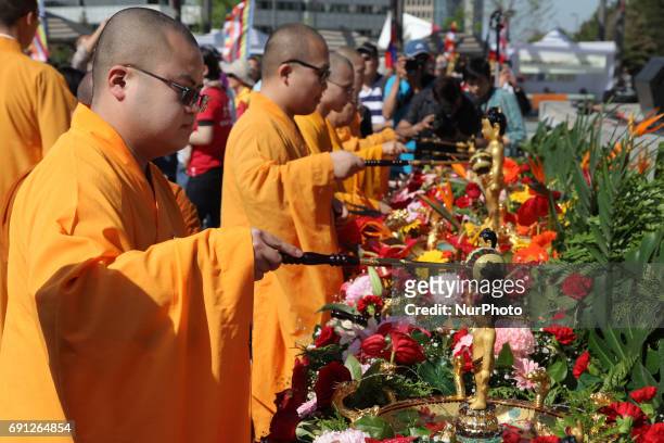 Buddhist monks bathe statues of the Child Buddha during the festival of Vesak in Mississauga, Ontario, Canada. Vesak commonly known as Lord Buddha's...