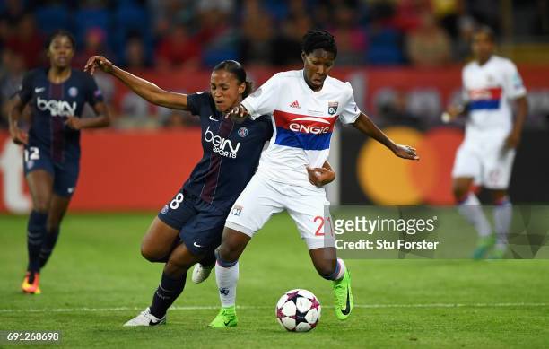 Kadeisha Buchanan of Olympique Lyonnais and Marie-Laure Delie of Paris Saint-Germain Feminines battle for the ball during the UEFA Women's Champions...