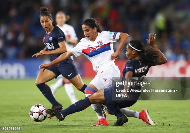 Amel Majri of Olympique Lyonnais takes on Perle Morroni and Veronica Boquete of Paris Saint-Germain Feminines during the UEFA Women's Champions...