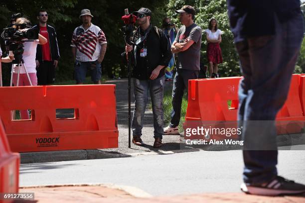 Activists monitor incoming traffic at the entrance of Westfield Marriott Hotel where the Bilderberg Meeting takes place June 1, 2017 in Chantilly,...