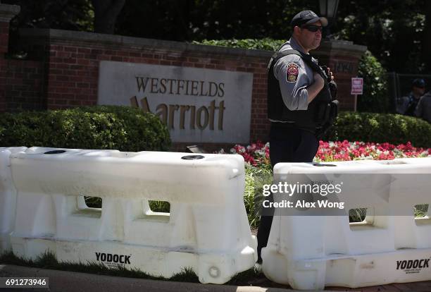 Member of Fairfax County Police stands guard at the entrance of Westfield Marriott Hotel where the Bilderberg Meeting takes place June 1, 2017 in...