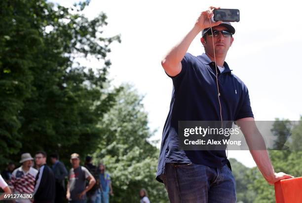 Activist Titus Frost monitors incoming traffic at the entrance of Westfield Marriott Hotel where the Bilderberg Meeting takes place June 1, 2017 in...