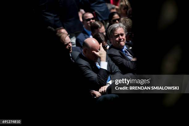 National Economic Council Director Gary Cohn and strategist Steve Bannon wait with others to hear US President Donald Trump announce the US will...