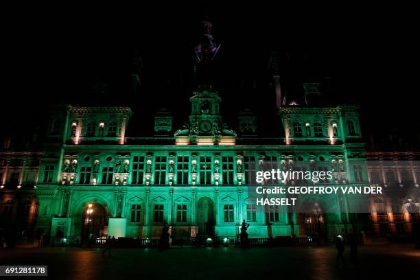 Picture taken on June 1 shows the City Hall of Paris illuminated in green following the announcement by US President Donald Trump that the United...