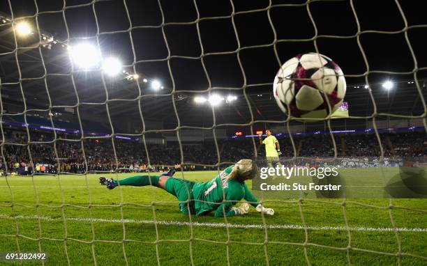 Sarah Bouhaddi of Olympique Lyonnais scores the winning penalty in the shoot out past goalkeeper Katarzyna Kiedrzynek of Paris Saint-Germain...