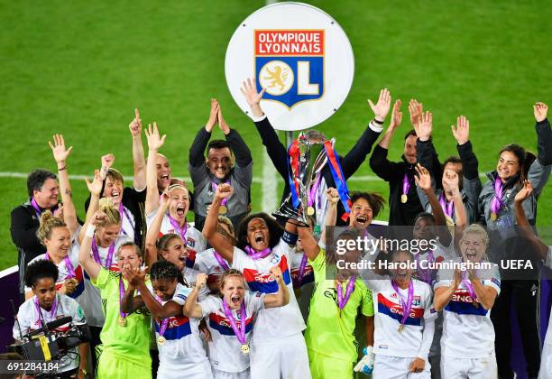 Wendie Renard and Sarah Bouhaddi of Olympique Lyonnais lift the trophy in victory after the UEFA Women's Champions League Final between Lyon and...