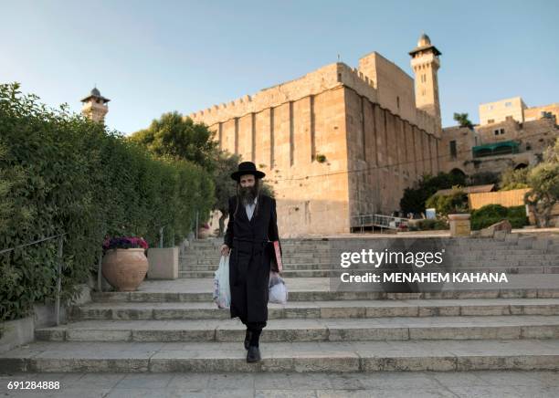 An Ultra-orthodox Jewish man walks outside the Patriarchs' Tomb, known in Arabic as the Ibrahimi Mosque, in the the divided West Bank city of Hebron...