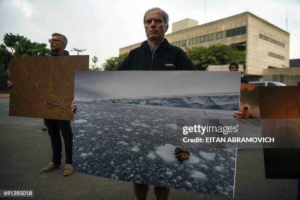 Greenpeace activists demonstrate outside the United States embassy in Buenos Aires, Argentina, on June 1 against US President Donald Trump's decision...