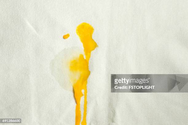 egg stain on white cloth - stained stock pictures, royalty-free photos & images