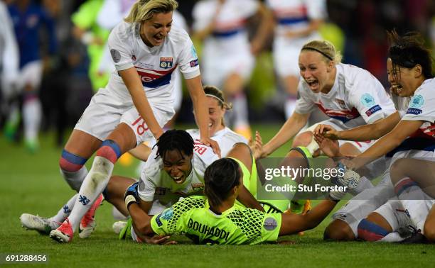 Olympic Lyon players race to celebrate with goalkeeper Sarah Bouhaddi who had scored the winning penalty during the UEFA Women's Champions League...