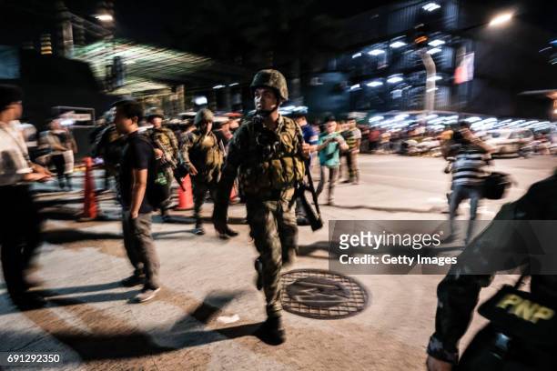 Filipino soldiers take their position outside Resorts World Manila after gunshots and explosions were heard in Pasay City on June 2, 2017 in Manila,...
