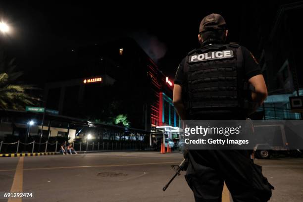 Members of the Philippine National police take their position outside Resorts World Manila after gunshots and explosions were heard in Pasay City on...