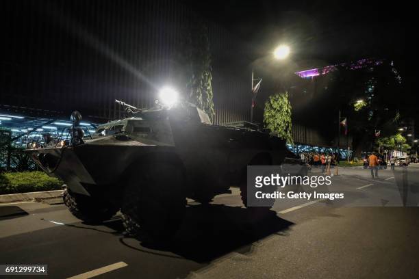An armoured personnel carrier takes position outside the Resorts World Manila after a shooting incident inside the entertainment resort in Pasay City...
