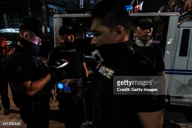 Members of the Philippine National Police take their position outside Resorts World Manila after gunshots and explosions were heard in Pasay City on...