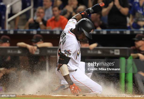Dee Gordon of the Miami Marlins scores on a two RBI hit by Giancarlo Stanton during a game against the Arizona Diamondbacks at Marlins Park on June...