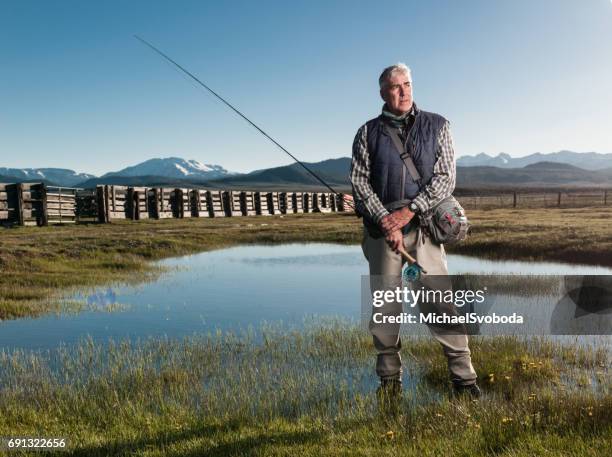 porträt von einem fliegenfischer - waders stock-fotos und bilder